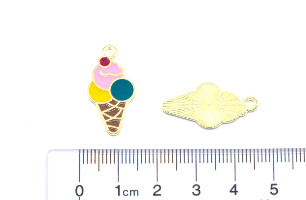 Two small jewelry charms on a white background: one ice cream cone pendant with pink, yellow, and blue scoops and a red cherry and the other is the charm showing the back. A ruler at the bottom shows their size.