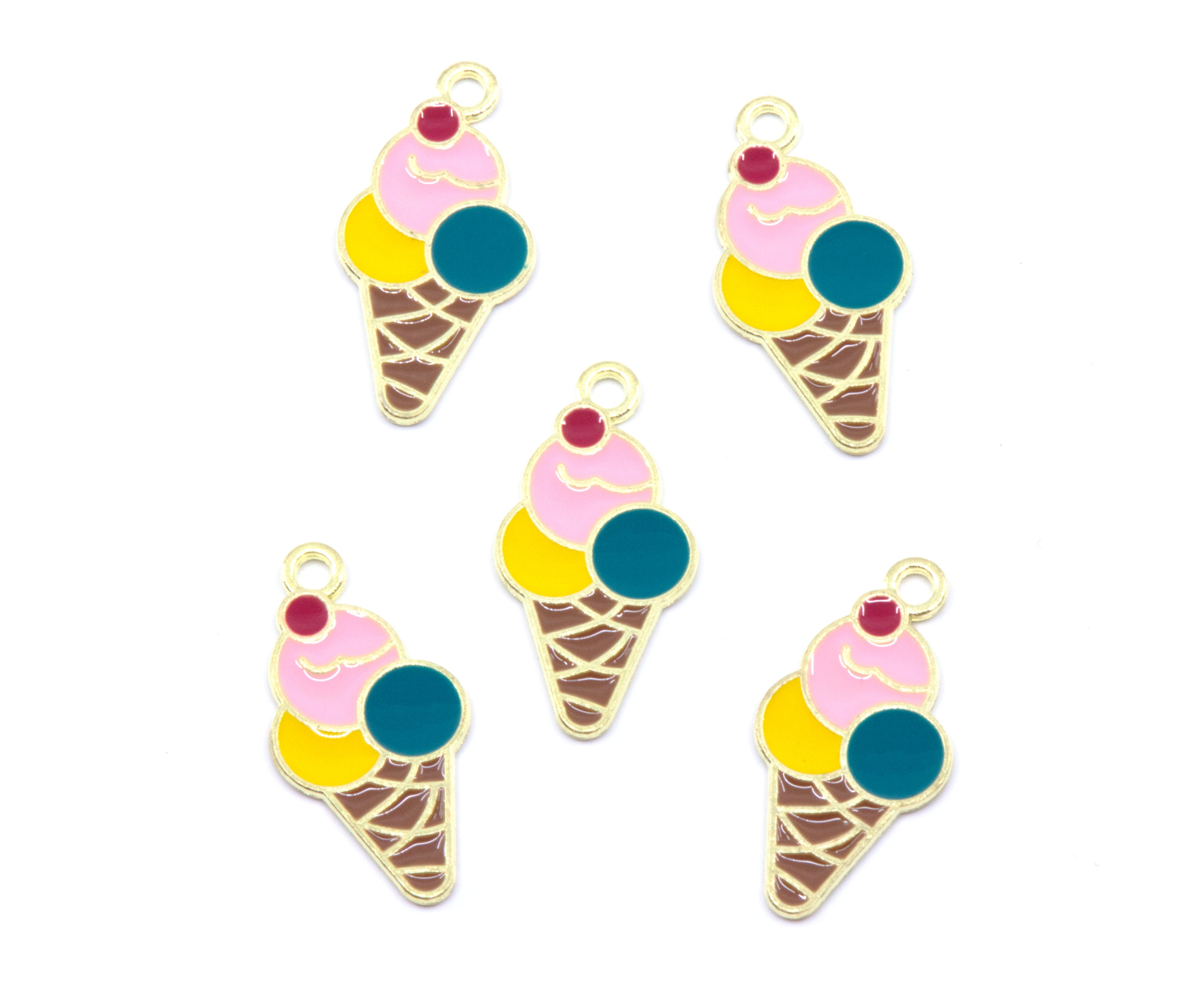 Five enamel ice cream cone charms with gold-tone metal outlines, featuring pink, yellow, and teal scoops with a small red cherry on top, arranged on a plain white background.
