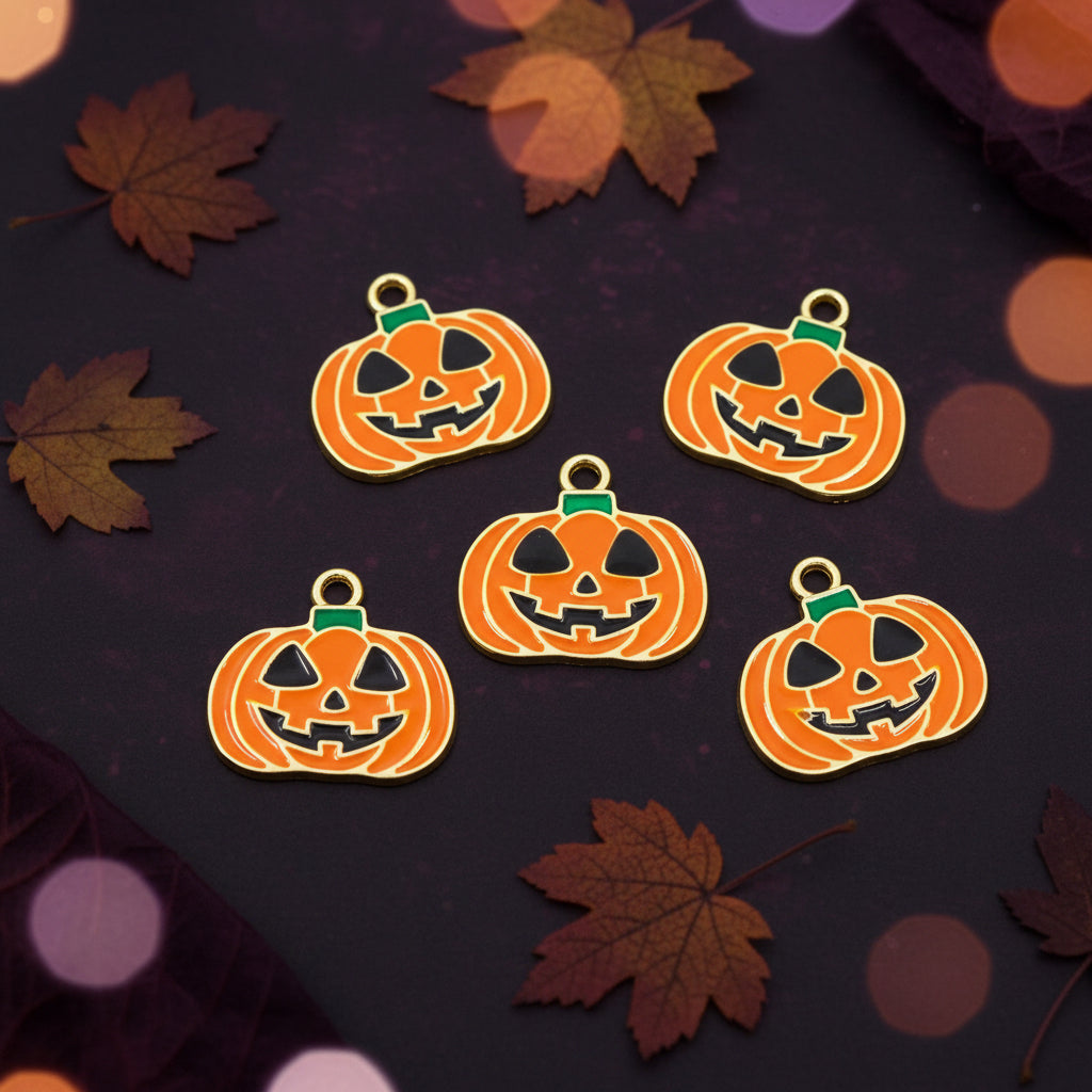 Five orange pumpkin charms with jack-o'-lantern faces and small green stems, arranged on a plain white background.