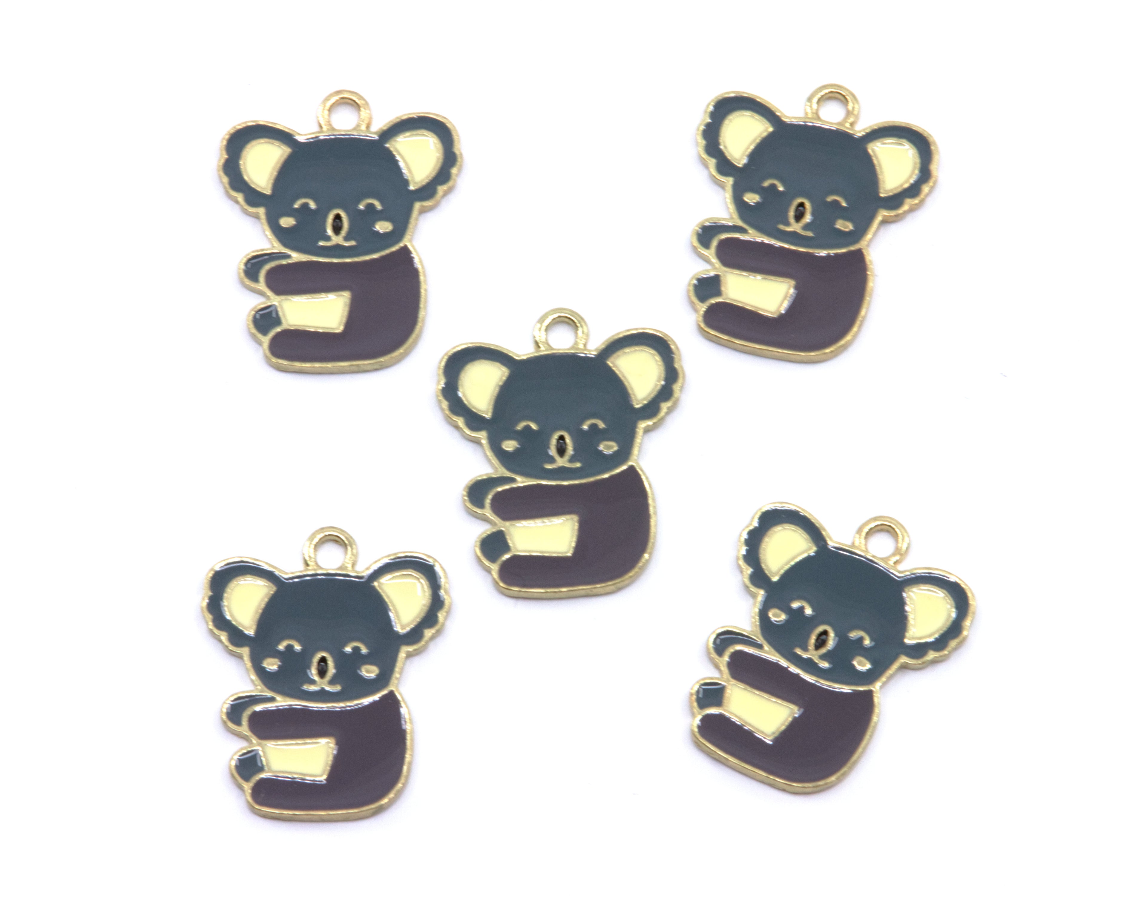Five small koala-shaped charms with gold-tone edges and loops at the top, shown on a plain white background.