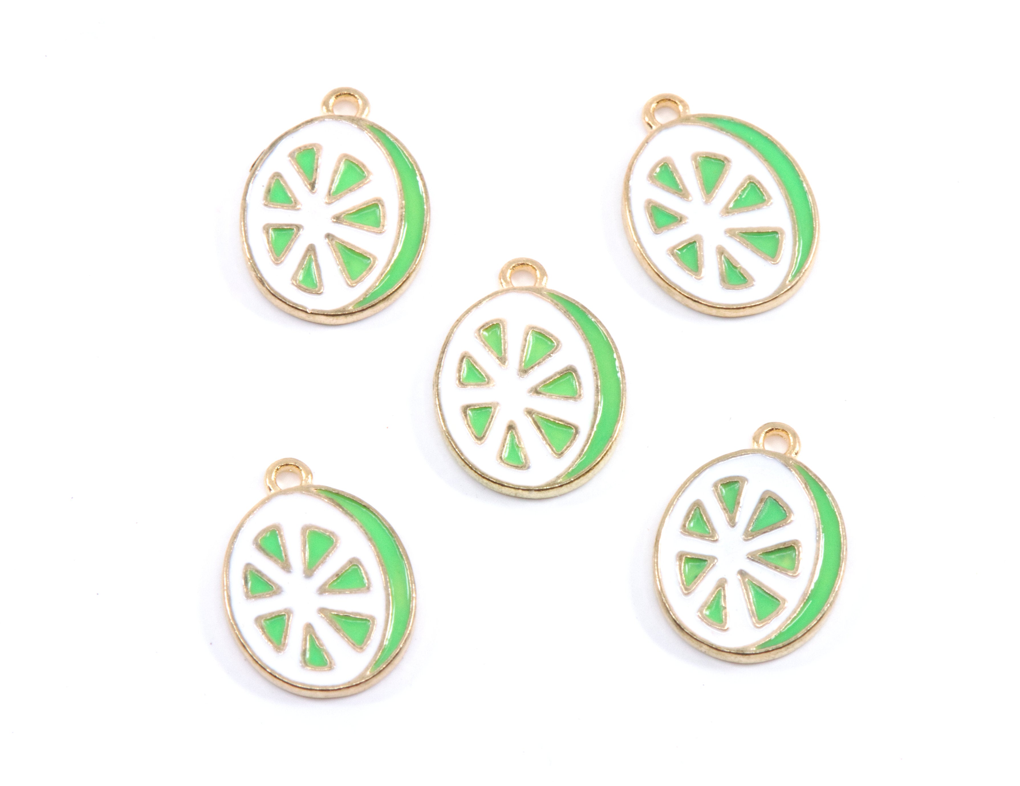 Five enamel charms shaped like lime slices, featuring a gold-tone metal border, white center, and bright green outer ring, arranged on a plain white background.