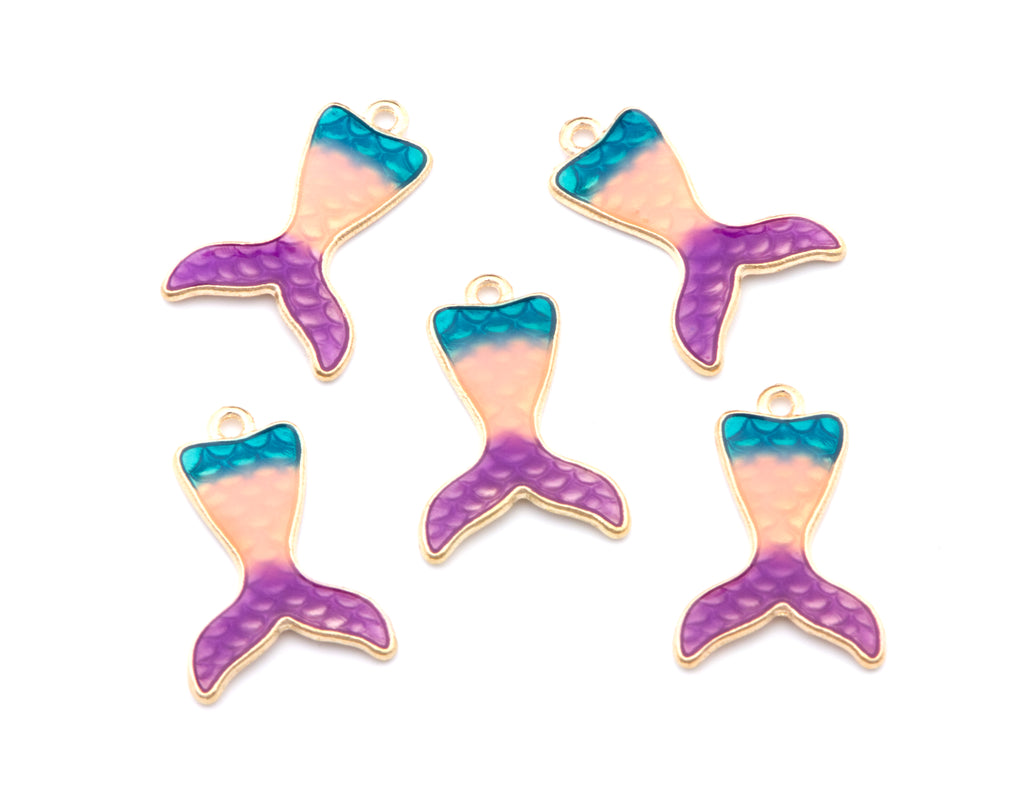 Five mermaid tail charms with a gold-tone outline, featuring a color gradient from teal blue to pink and purple, arranged on a plain white background.