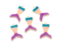 Five mermaid tail charms with a gold-tone outline, featuring a color gradient from teal blue to pink and purple, arranged on a plain white background.