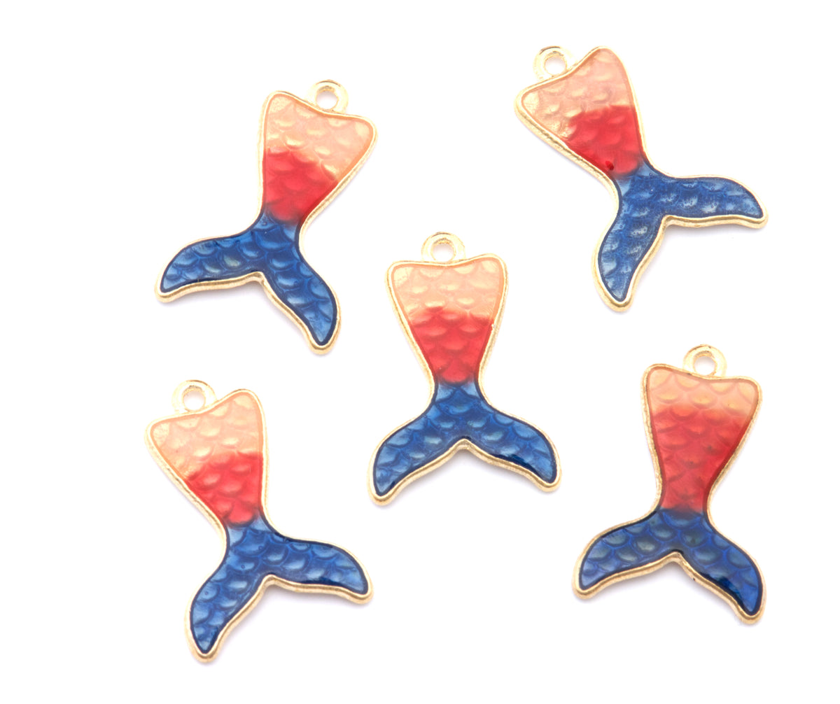 Five mermaid tail charms with a textured finish, featuring a color-blocked design of peach, red, and blue scales with gold-tone metal borders, arranged on a plain white background.