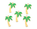 Five small palm tree charms with green enamel leaves and light brown trunks, arranged on a plain white background.