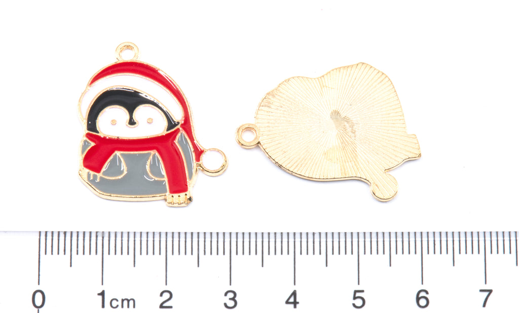 Two gray penguin wearing Santa hat and scarf charms shown on a white background above a ruler for scale.