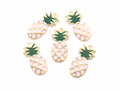 Five pineapple-shaped jewelry charms with gold-tone metal outlines, light pink enamel bodies, and dark green crown tops, arranged on a plain white background.