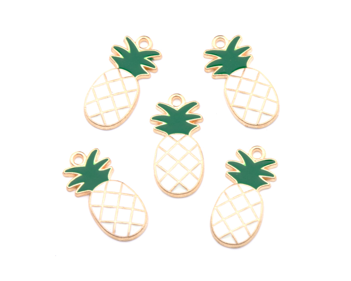 Five pineapple-shaped jewelry charms with white enamel bodies, green leafy tops, and gold-tone metal outlines, arranged on a plain white background.