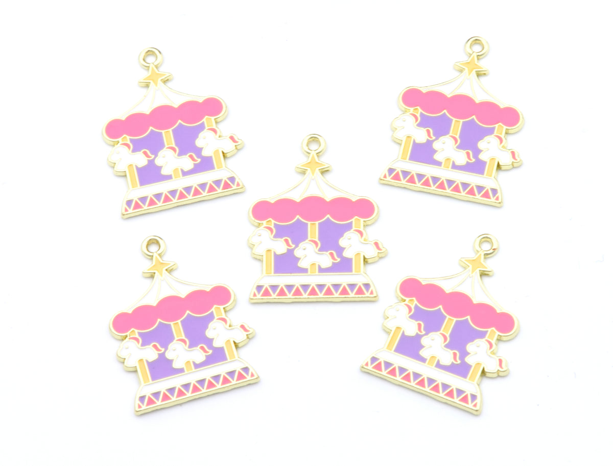 Six miniature carousel and circus-themed charms in pastel pink, lavender, cream, and gold, arranged on a plain white background.