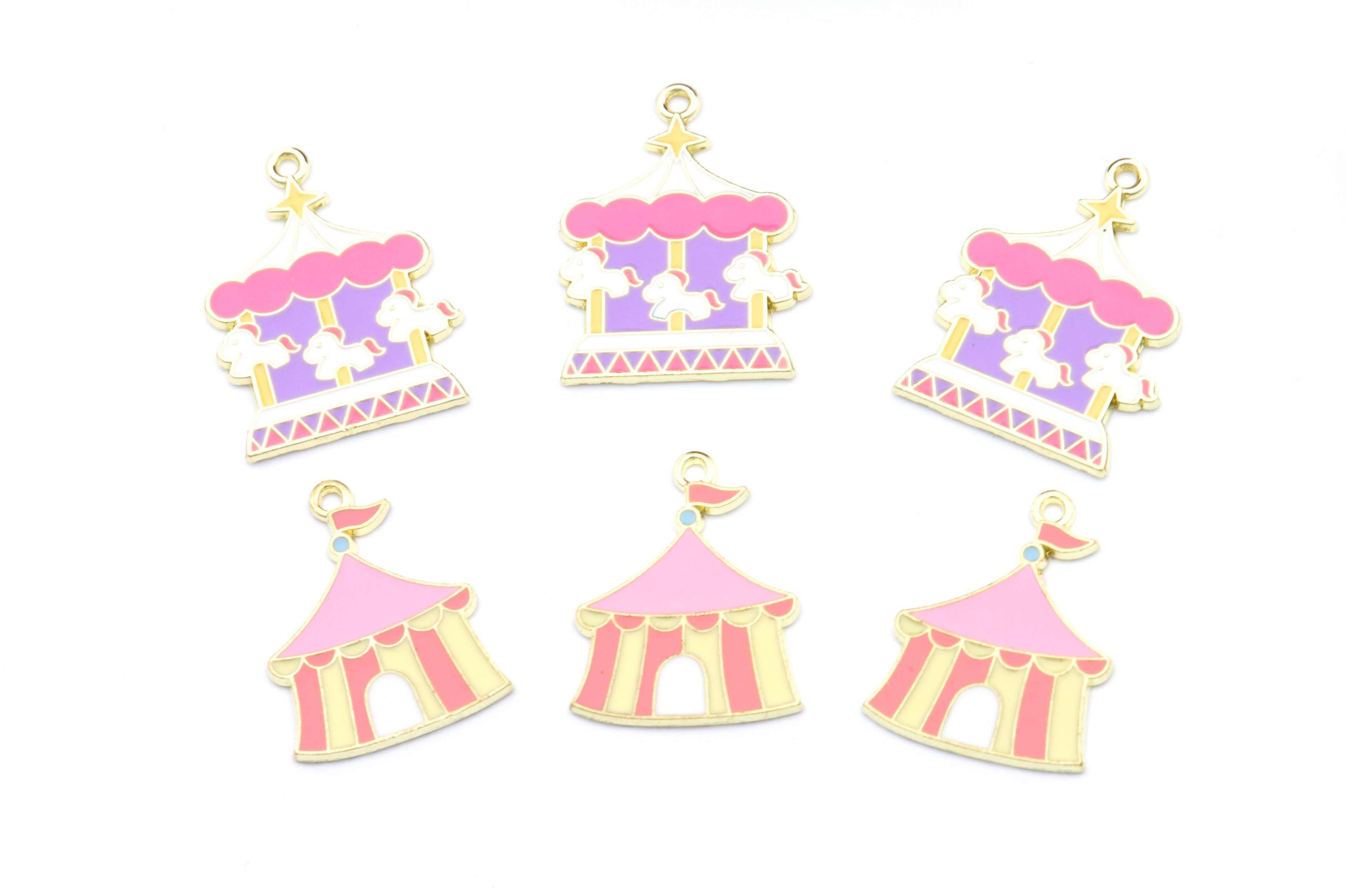 Six miniature carousel and circus-themed charms in pastel pink, lavender, cream, and gold, arranged on a plain white background.