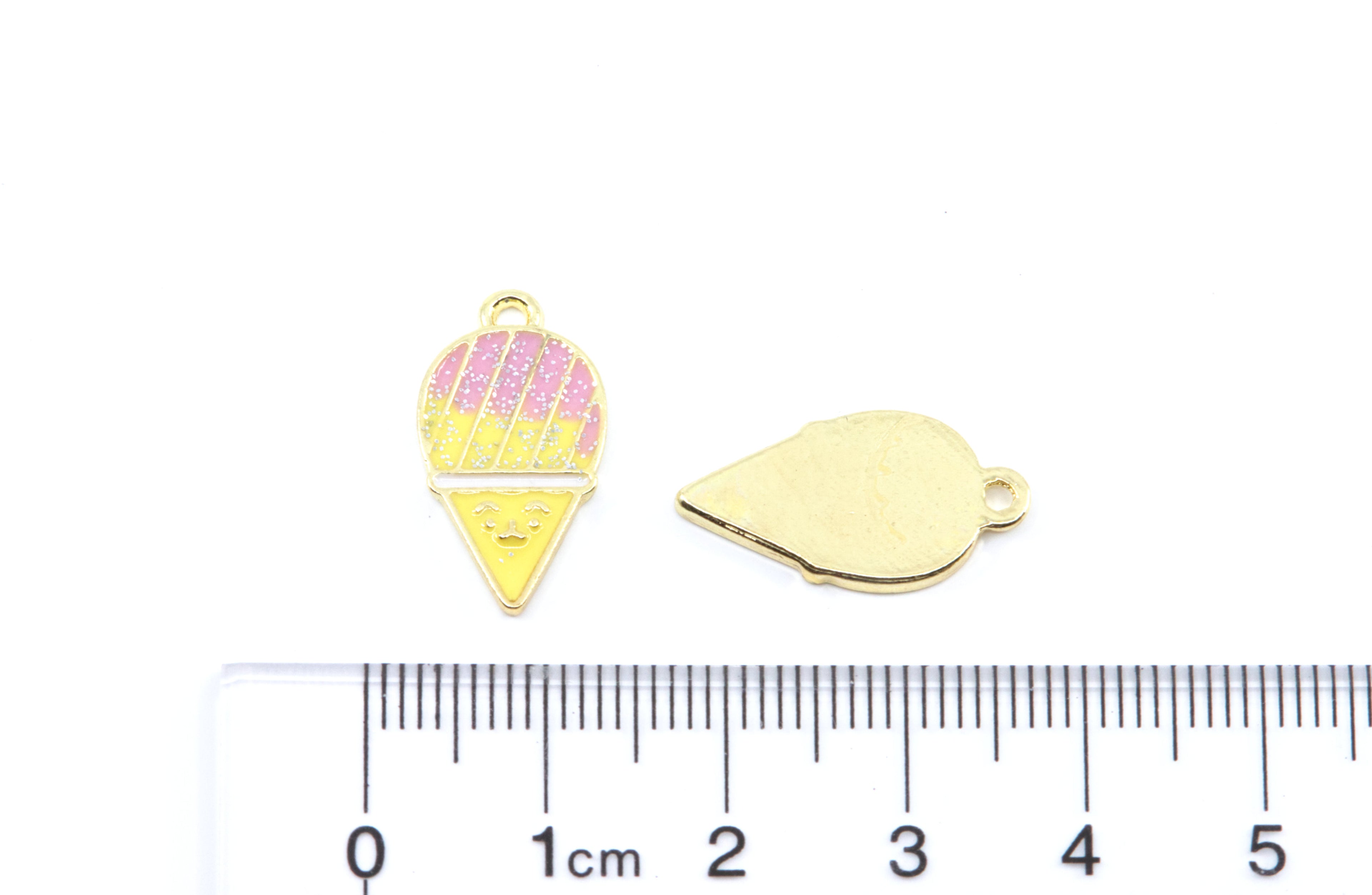 Two pink and yellow snow cone charms on a white background with a cm ruler below for scale