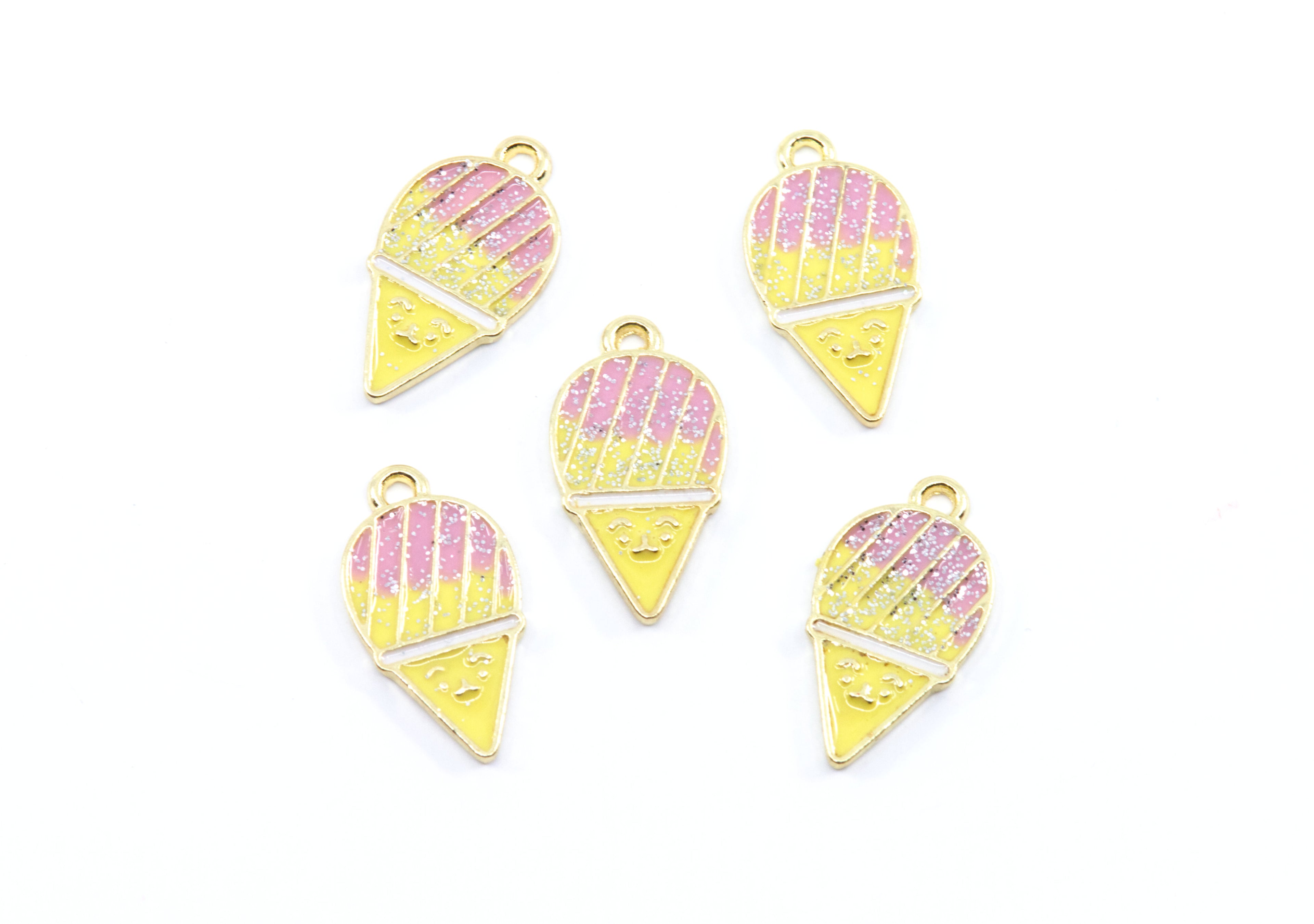 Five gold-plated snowcone charms with pink and yellow glitter enamel, arranged on a plain white background.