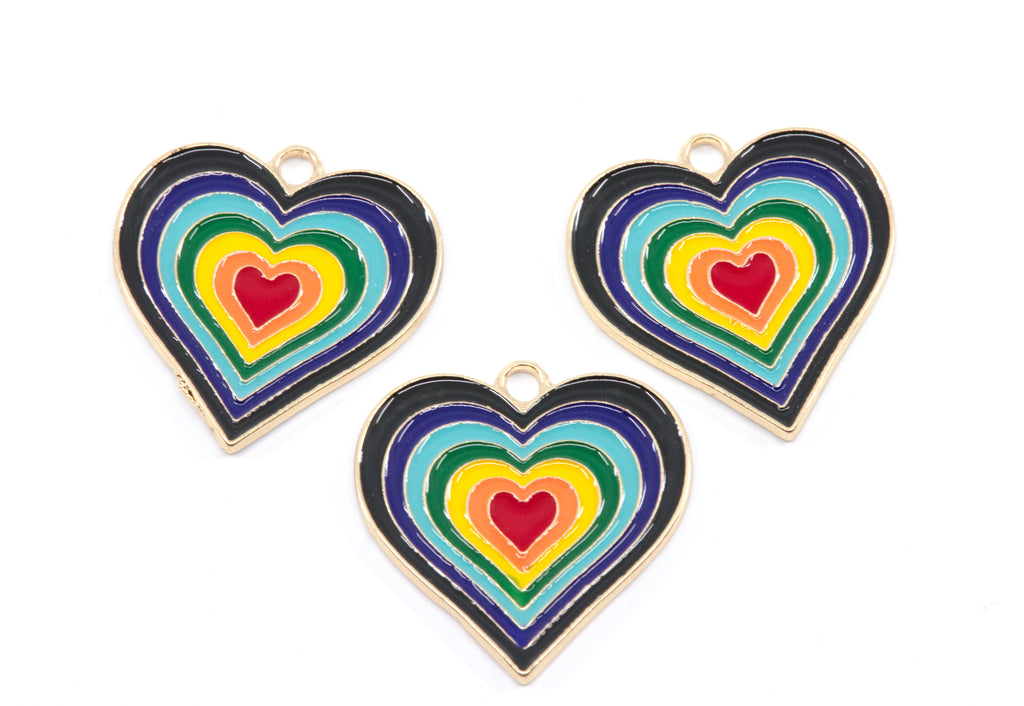 Three heart-shaped enamel jewelry charms with concentric rainbow heart designs and gold-tone borders, arranged on a plain white background.