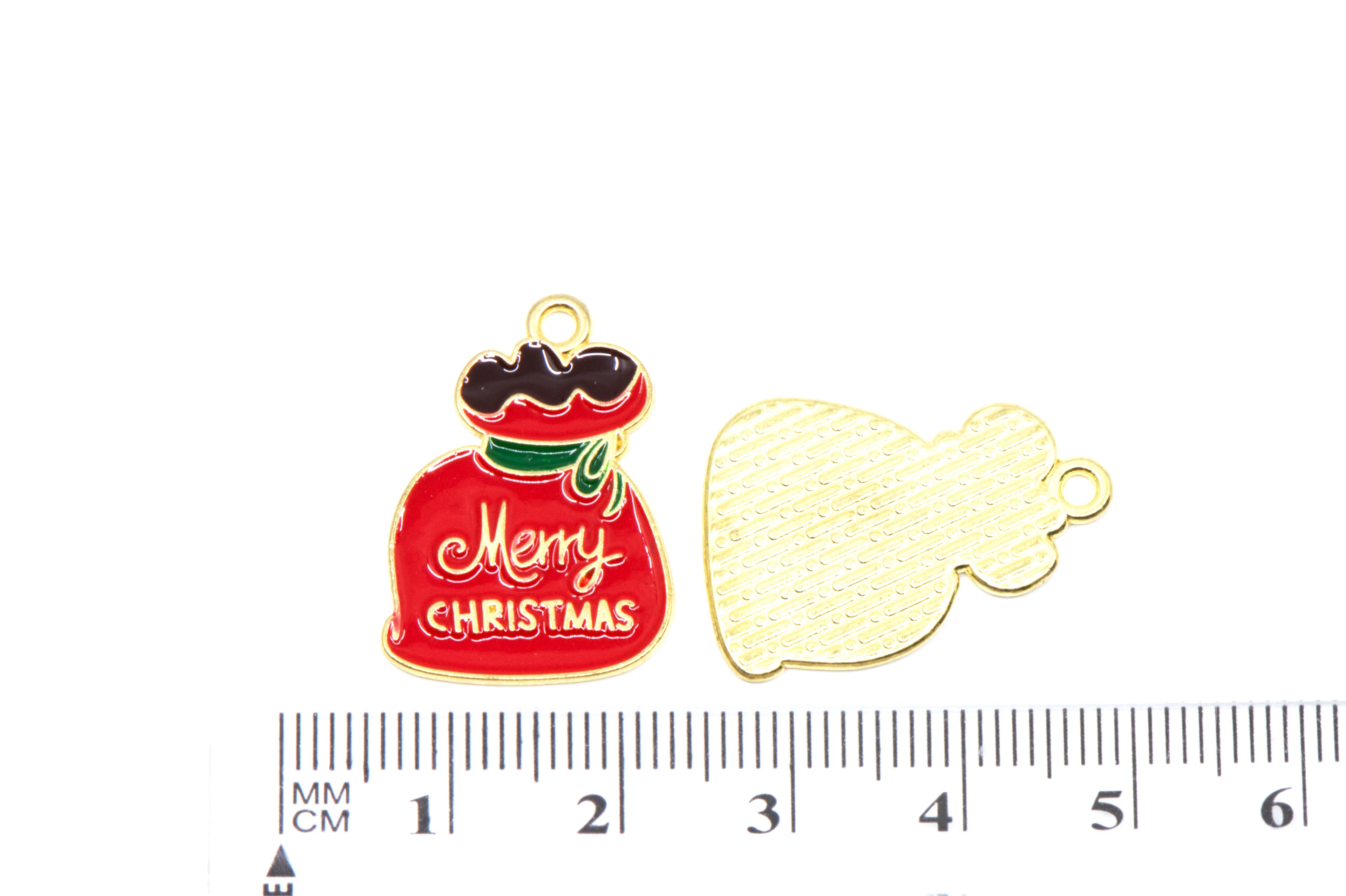 Two red Santa bag Christmas-themed metal charms, displayed above a ruler for scale on a white background.