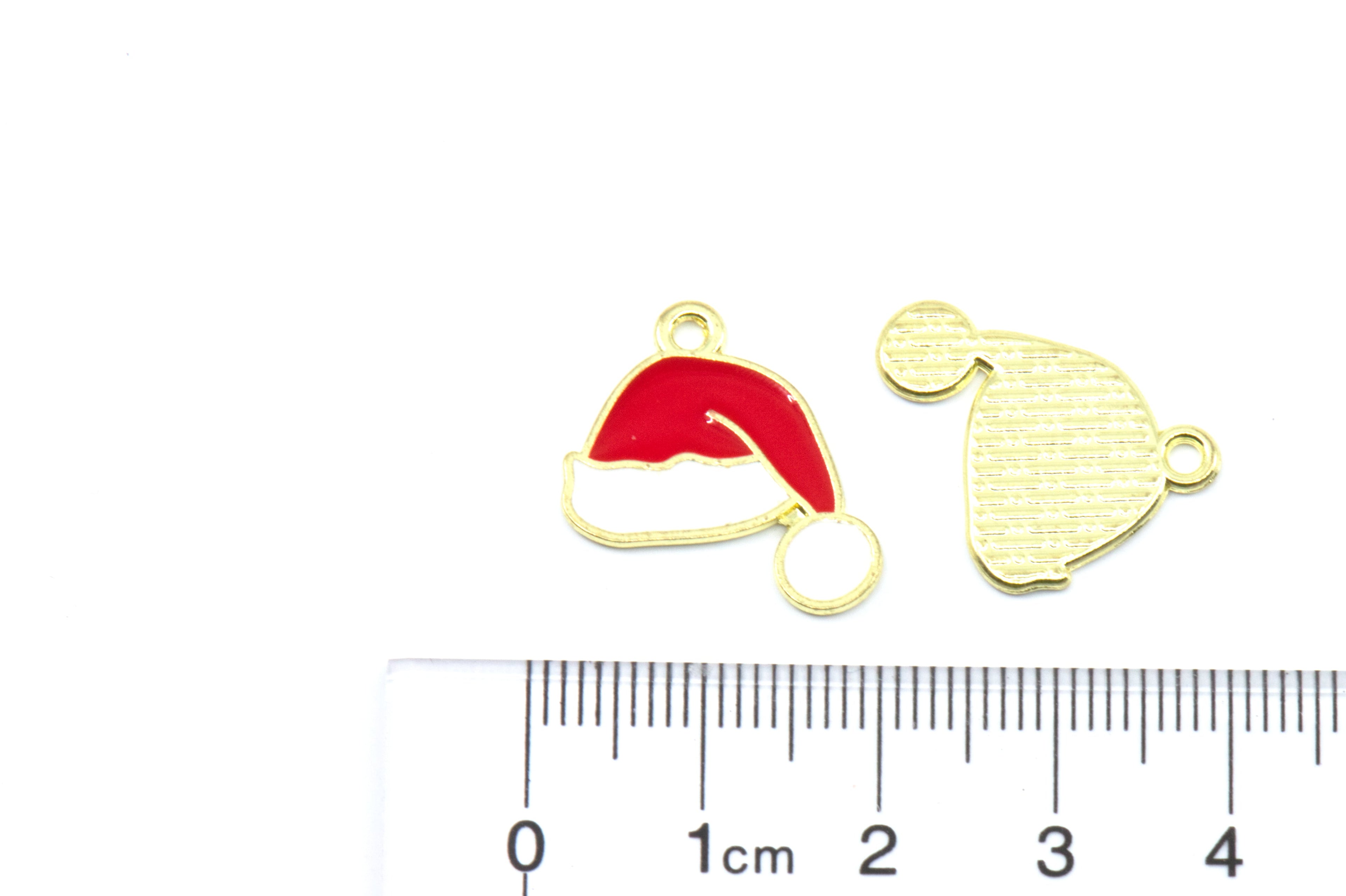 Two red Santa hat enamel charms shown next to a white cm ruler for scale on a white background.