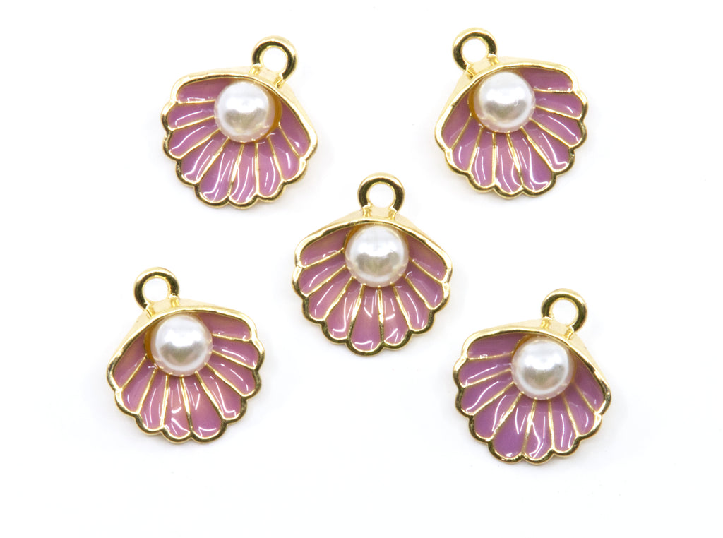 Five seashell-shaped jewelry charms with gold-tone metal edges, purple enamel detailing, and a white faux pearl in the center, arranged on a plain white background.