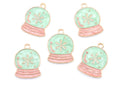 Five snow globe jewelry charms with light blue enamel, pink striped bases, and gold-tone metal borders on a white background.