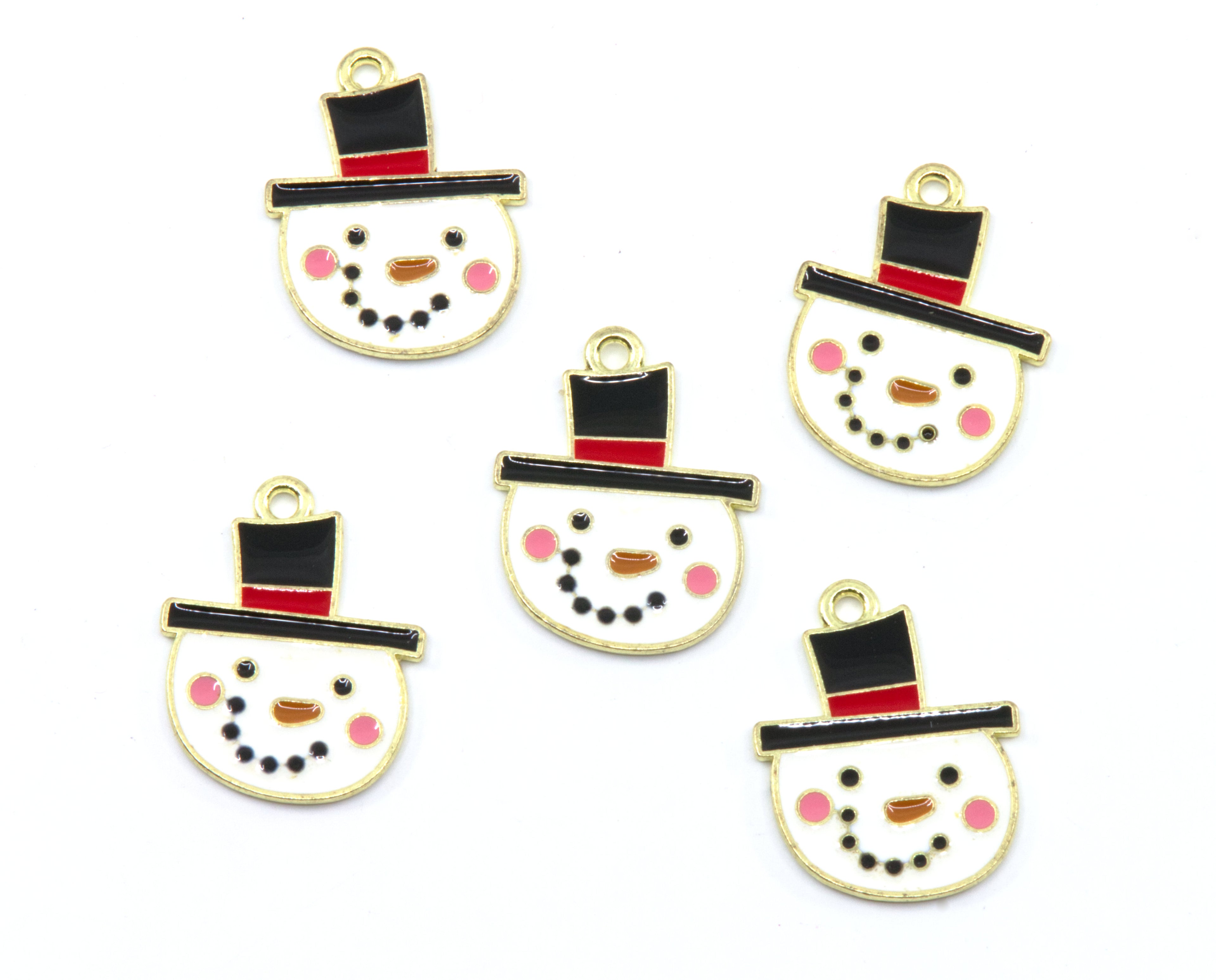 Five snowman face charms with gold-tone metal borders, black top hats, red bands, pink cheeks, and black dot facial features on a white background.