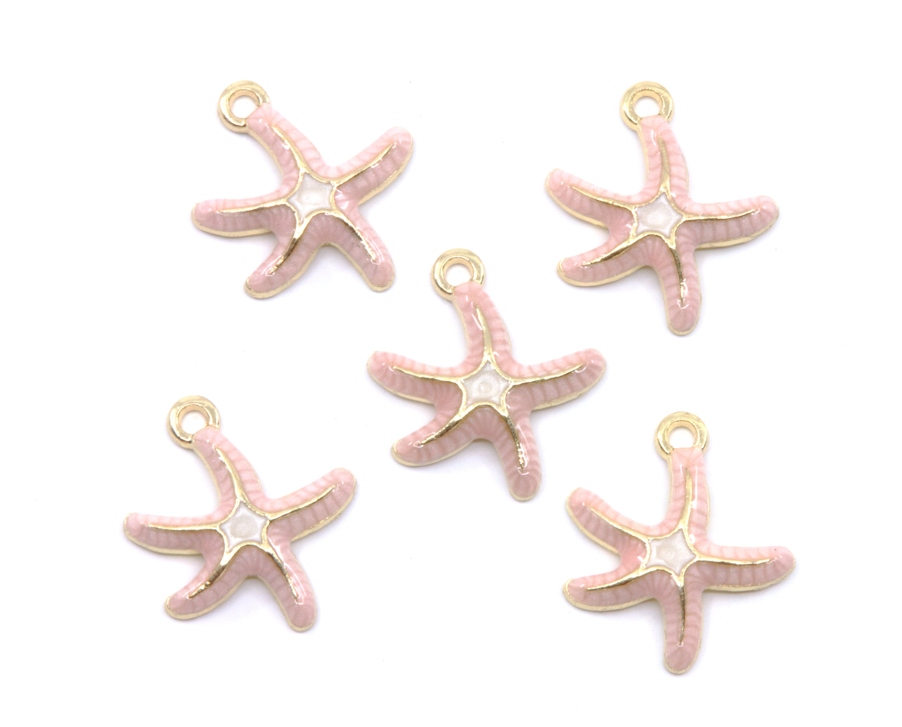 Five pink starfish charms with gold-tone metal outlines and loops, arranged on a plain white background.