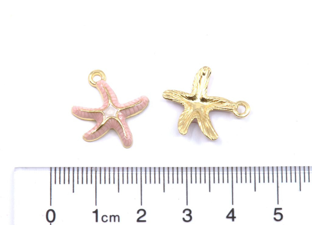Two small starfish-shaped jewelry charms shown above a cm ruler for scale on a white background.