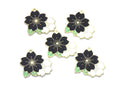 Five flower charms with black, white, and light green enamel details, arranged on a plain white background