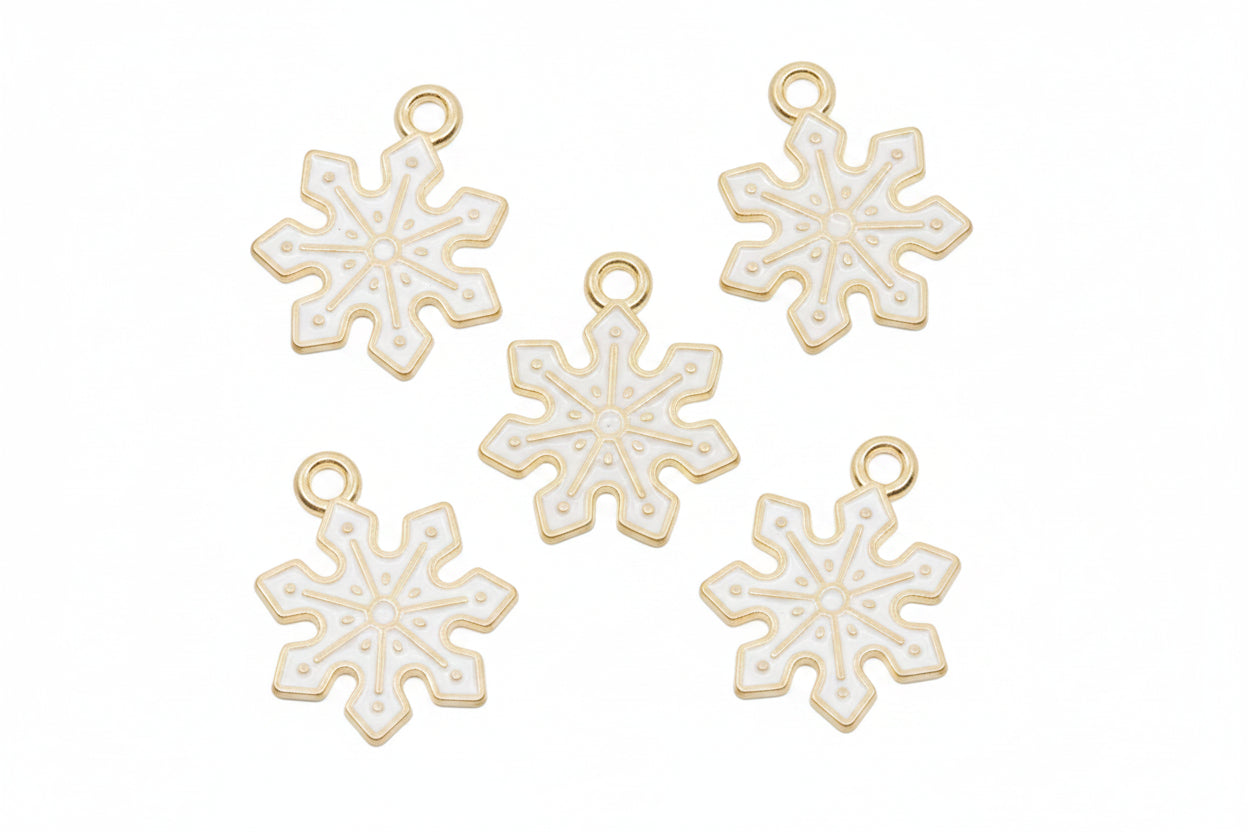 Five white snowflake-shaped jewelry charms with gold-tone loops at the top, arranged on a white background.