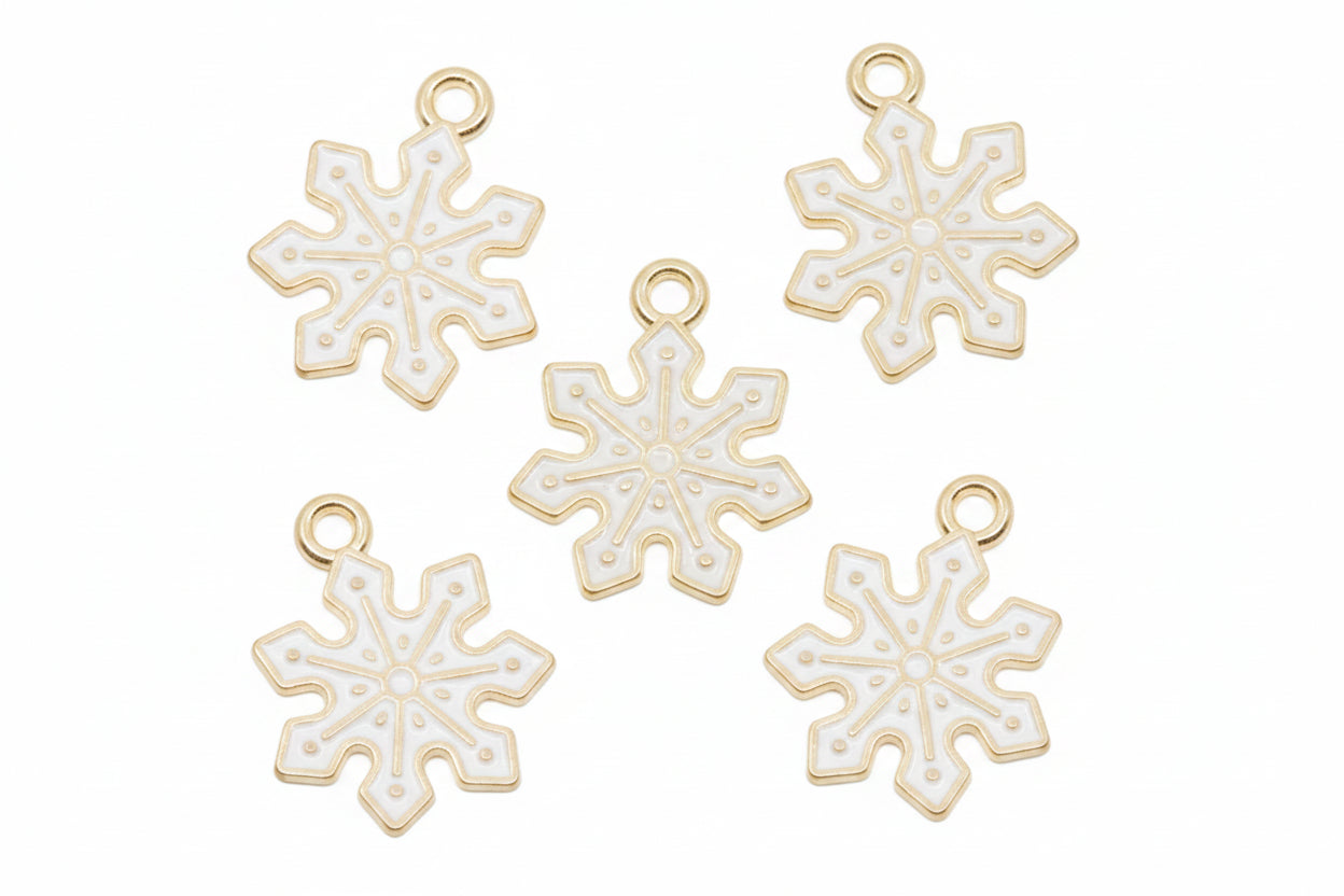 Five white snowflake-shaped jewelry charms with gold-tone loops at the top, arranged on a white background.