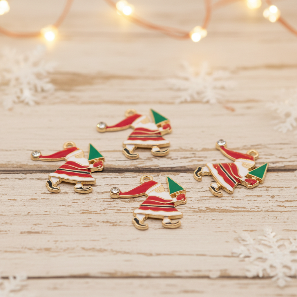 Four small Santa Claus-shaped charms with red and white outfits carrying green trees are arranged on a light wood surface with blurred string lights and snowflake decorations in the background.