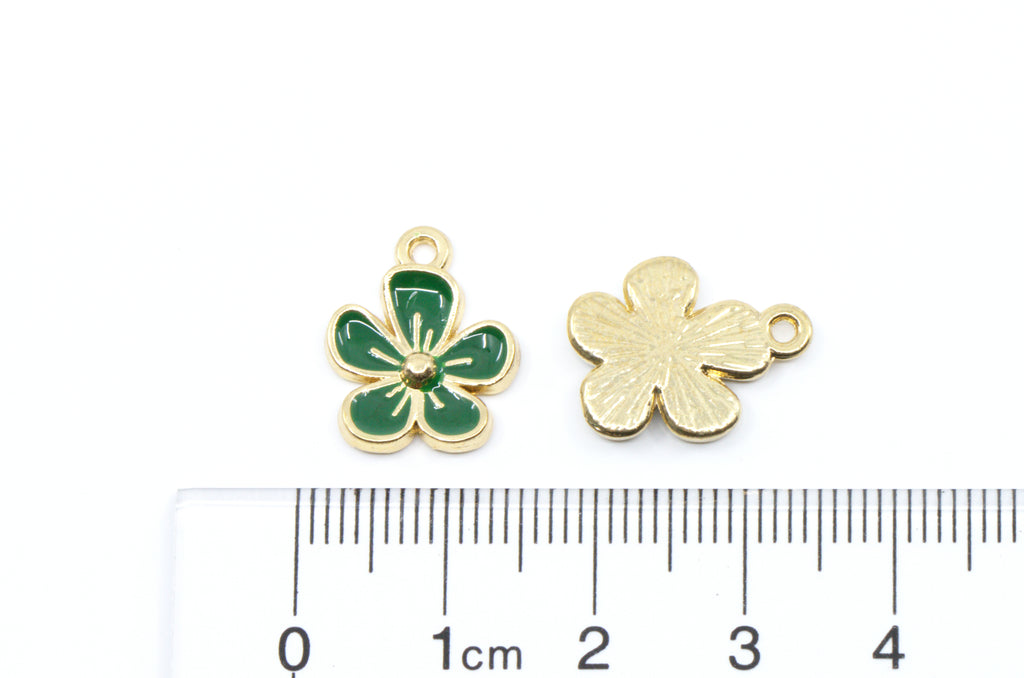 Two small flower charms, shown next to a cm ruler for scale on a white background.