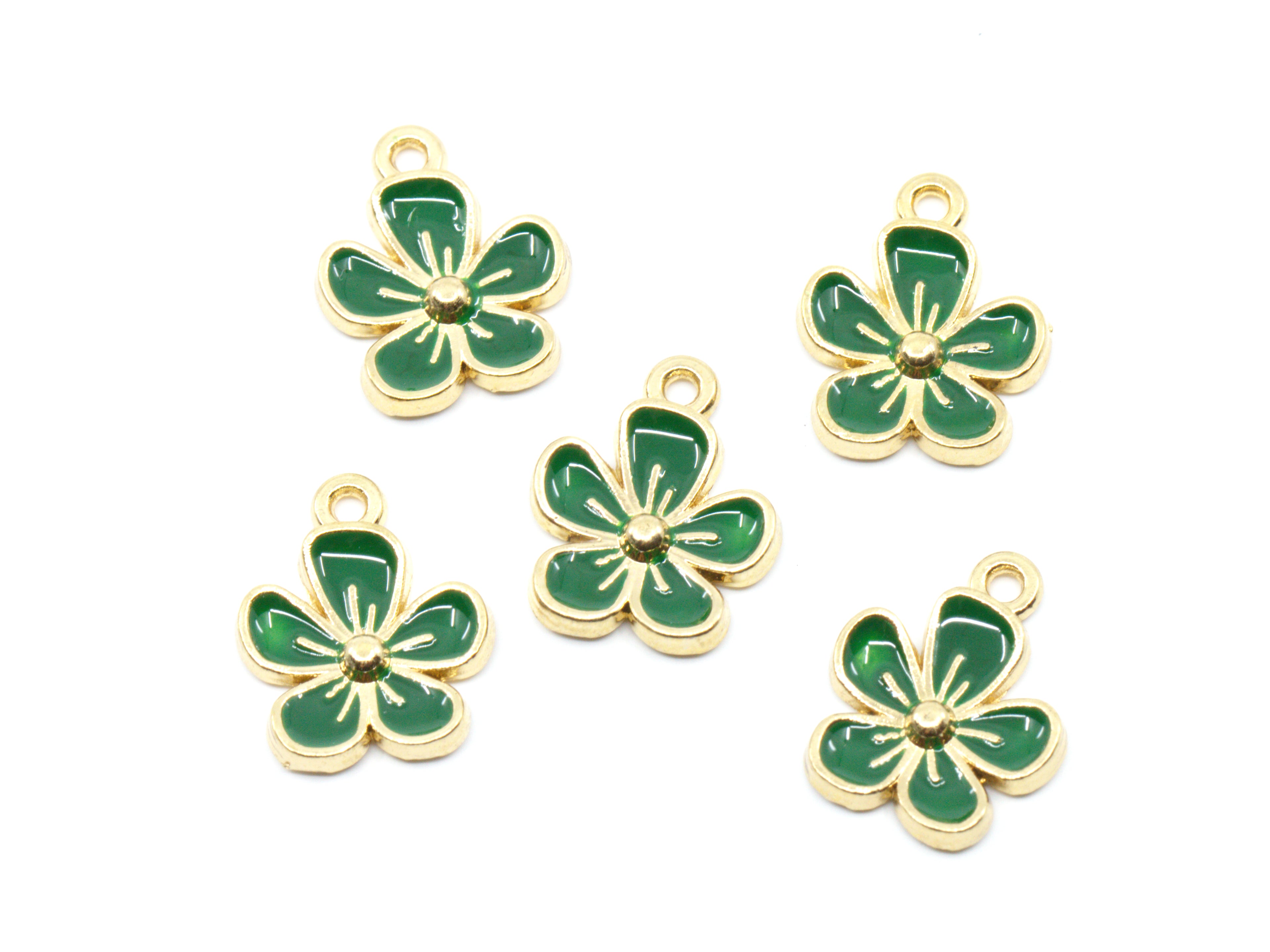 Five green enamel flower charms with gold-tone metal borders and loops, arranged on a plain white background.