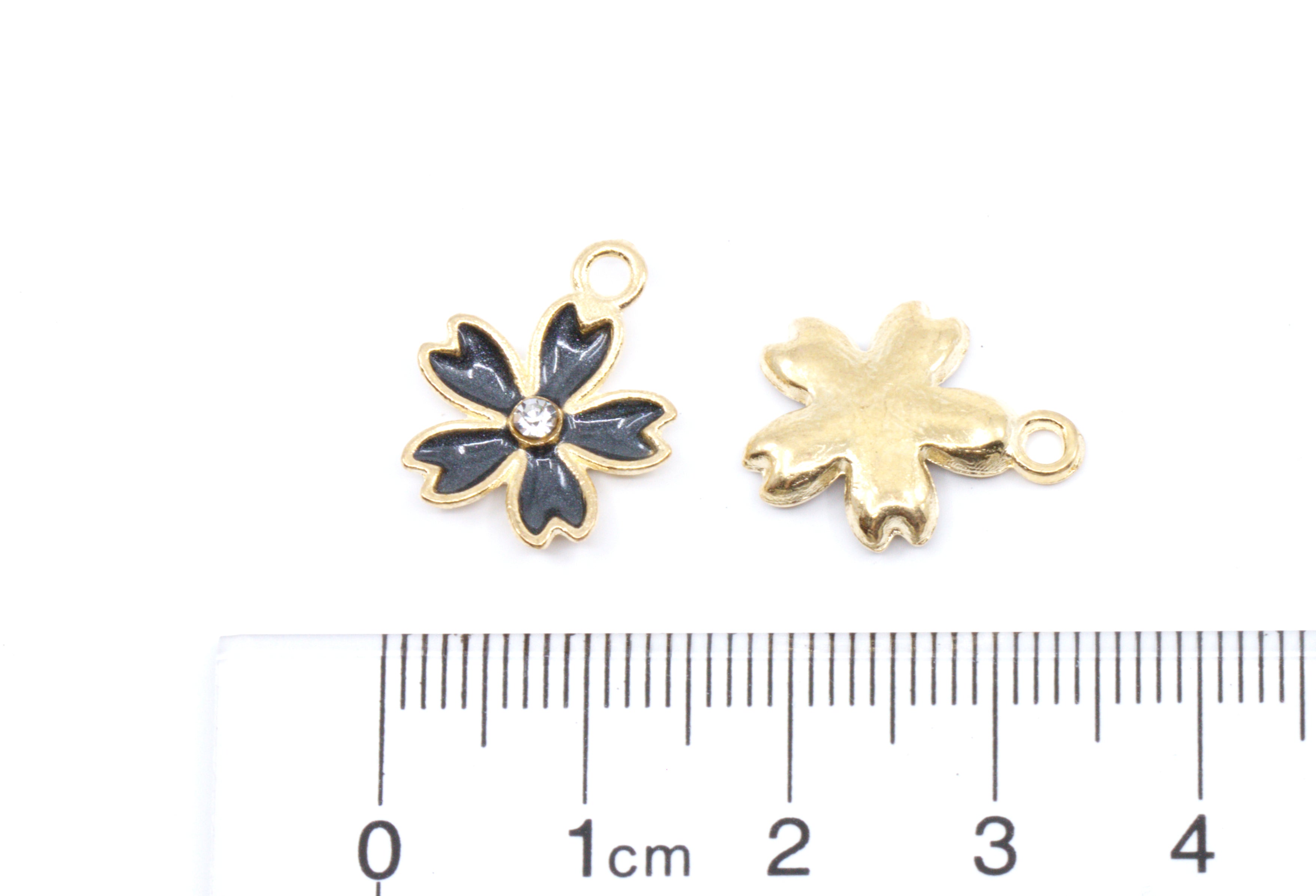 Two small gold-tone flower-shaped jewelry charms shown on a white background, with one front view and one back view, alongside a cm ruler for scale.