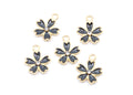 Five gray and gold flower-shaped jewelry charms with a clear rhinestone in the center, arranged on a plain white background.