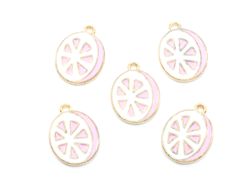 Five round enamel charms shaped like sliced  grapefruit, featuring a white center with pink segments and a gold-tone border, arranged on a plain white background.