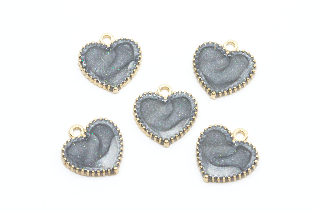 Five heart-shaped jewelry charms with a  gray center and gold-tone edges, arranged on a plain white background.