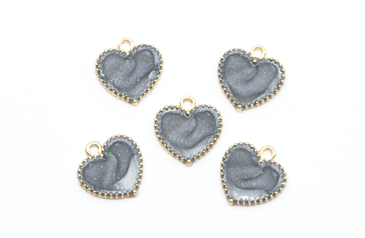 Five heart-shaped jewelry charms with a  gray center and gold-tone edges, arranged on a plain white background.
