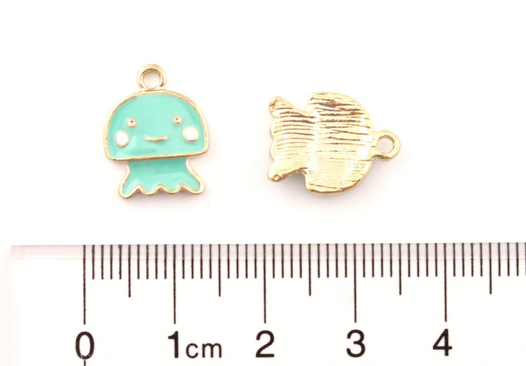 Two small jewelry charms shown above a ruler for scale: a mint green jellyfish charm on the left and the charm's backside on the right, on a white background.