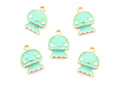 Five mint green jellyfish charms with gold-plated edges and white facial details, arranged on a plain white background.