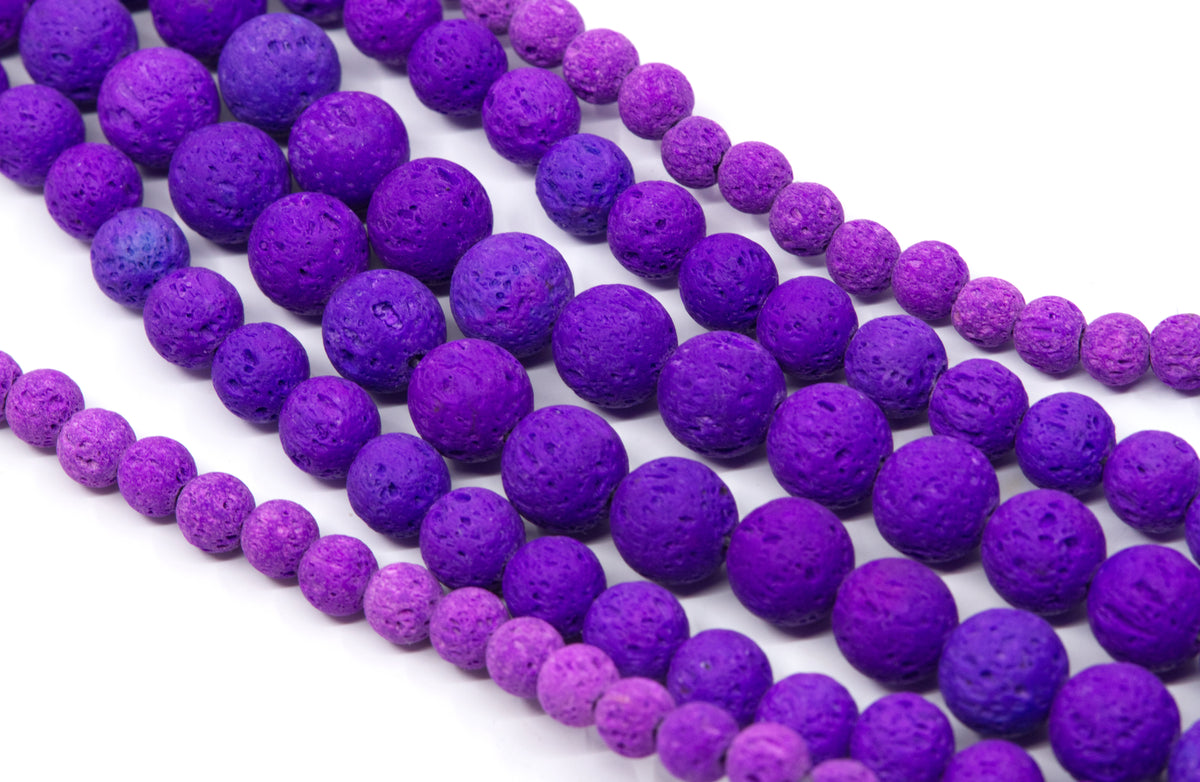 Purple and lava stone bead strands on a white background.