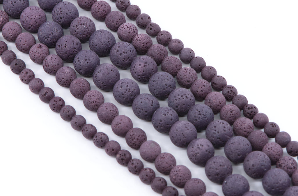 Multiple strands of porous purple lava stone beads in varying sizes, displayed diagonally on a clean white background.