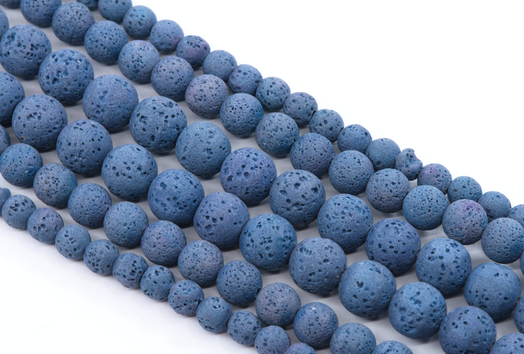 multiple strands of Blue porous lava stone beads arranged in diagonal strands on a white background.