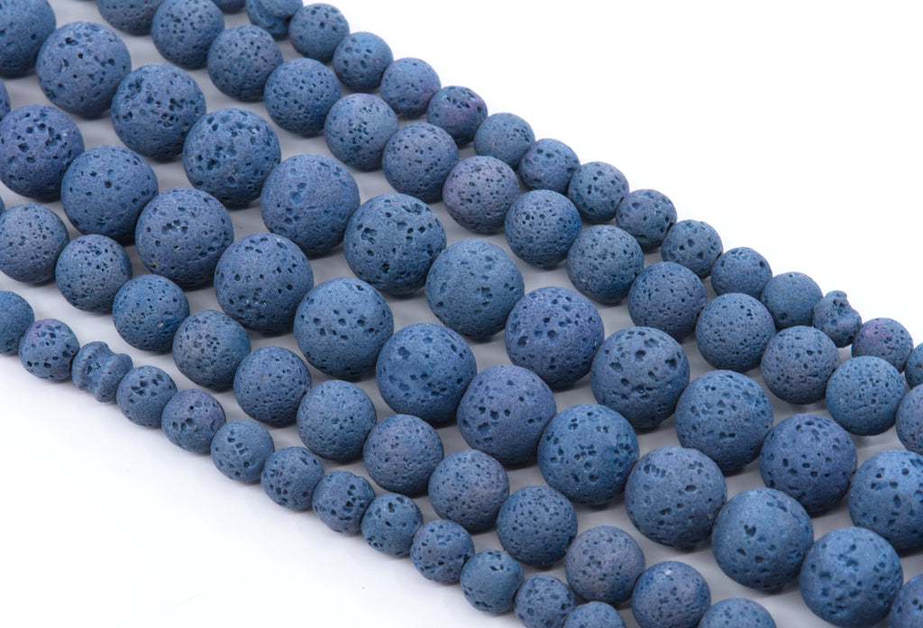 multiple strands of Blue porous lava stone beads arranged in diagonal strands on a white background.
