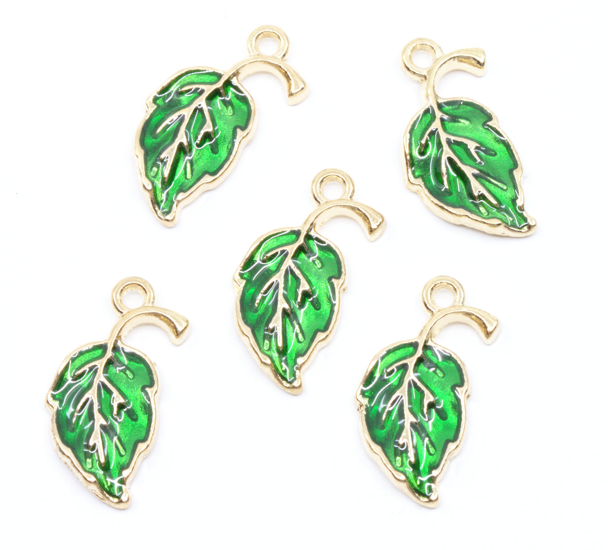 Five green leaf-shaped jewelry charms with gold-tone metal borders and hanging loops, arranged on a plain white background.