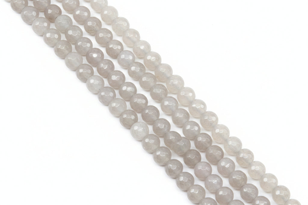 Faceted round agate beads in pale gray  arranged in diagonal rows on a light gray background.