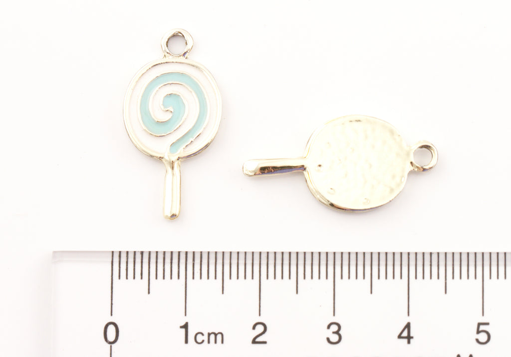 Two blue and white lollipop charms shown on a white background with a ruler at the bottom for scale. 