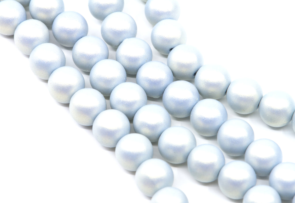 multiple strands of shimmery blue acrylic beads shown on a white background 