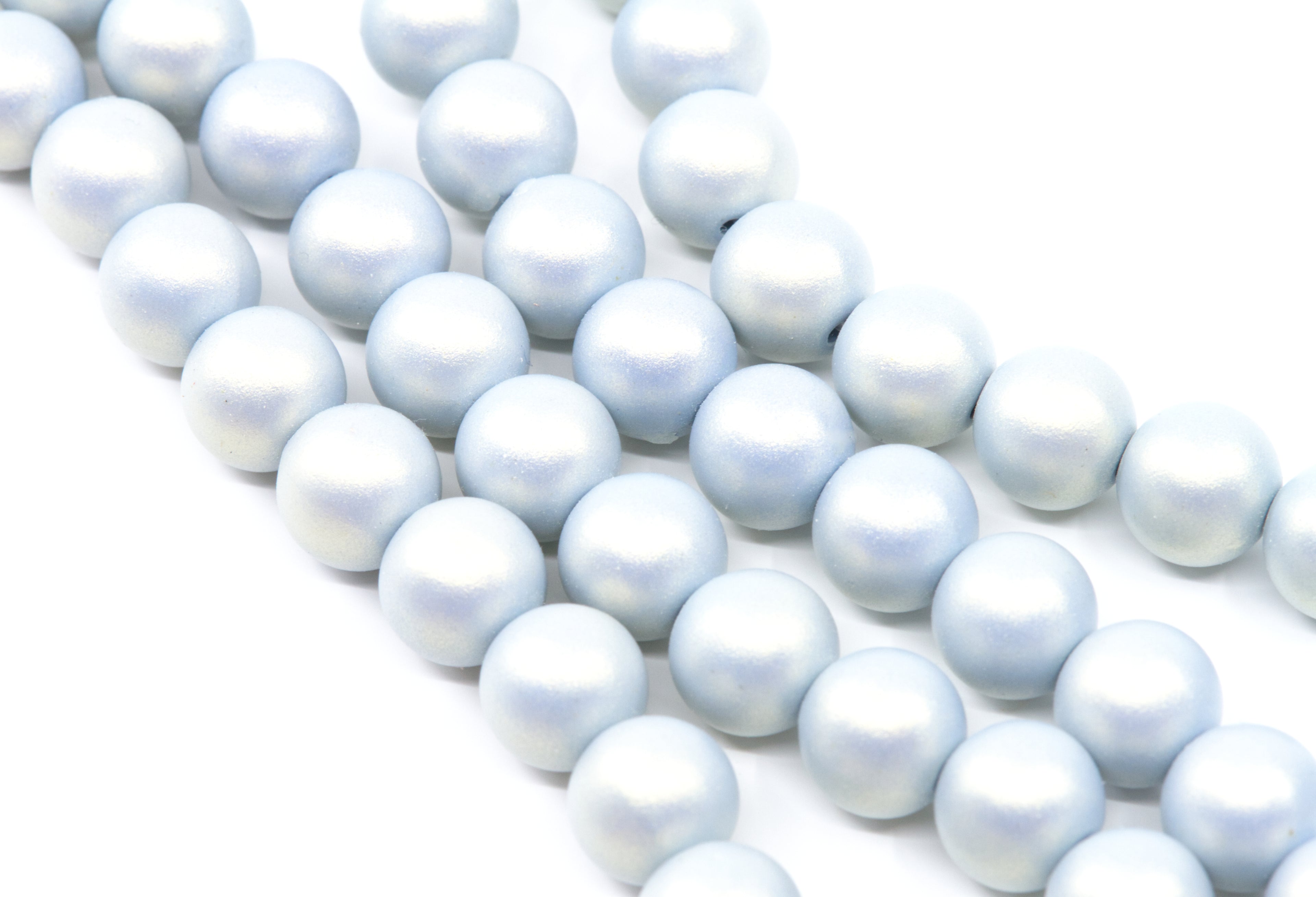 multiple strands of shimmery blue acrylic beads shown on a white background 