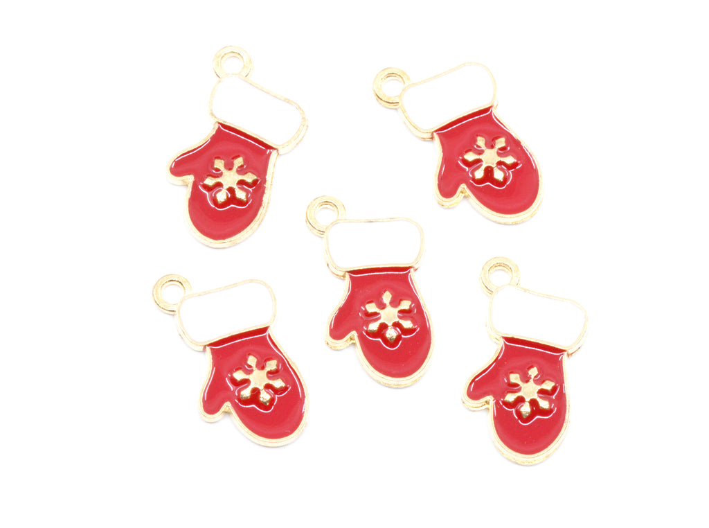 Five red mitten-shaped charms with gold-tone metal outlines, white cuff details, and gold snowflake motifs, arranged on a plain white background.