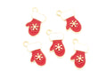 Five red mitten-shaped charms with gold-tone metal outlines, white cuff details, and gold snowflake motifs, arranged on a plain white background.