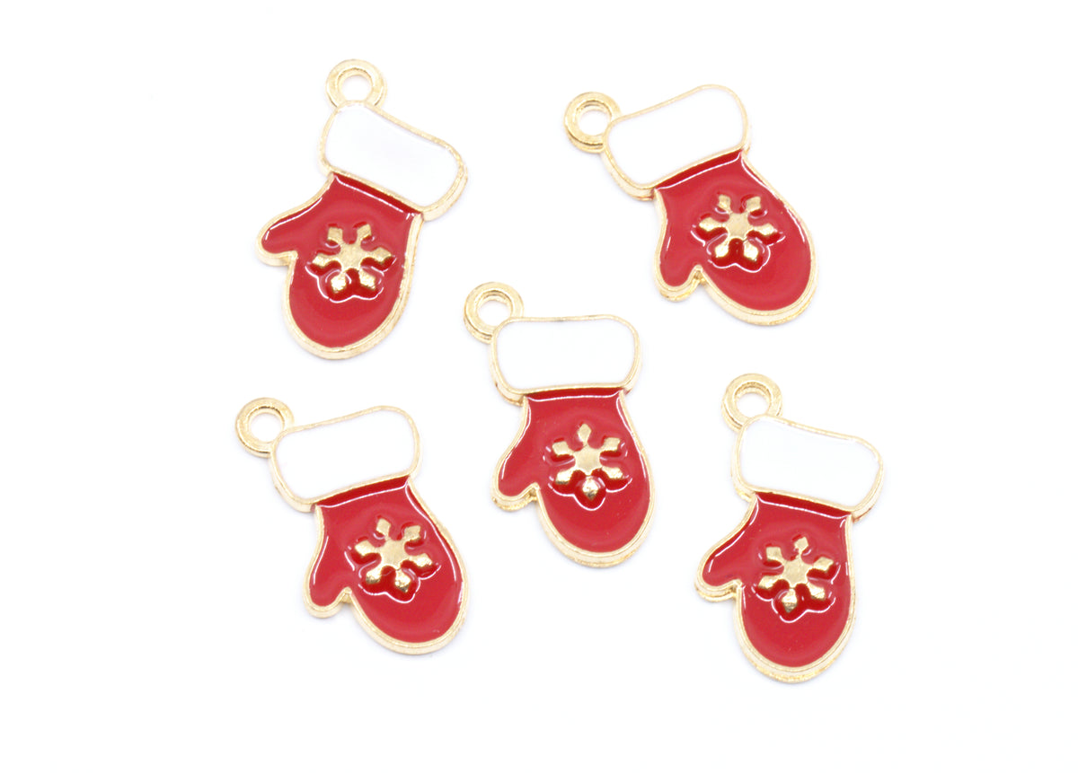 Five red mitten-shaped charms with gold-tone metal outlines, white cuff details, and gold snowflake motifs, arranged on a plain white background.