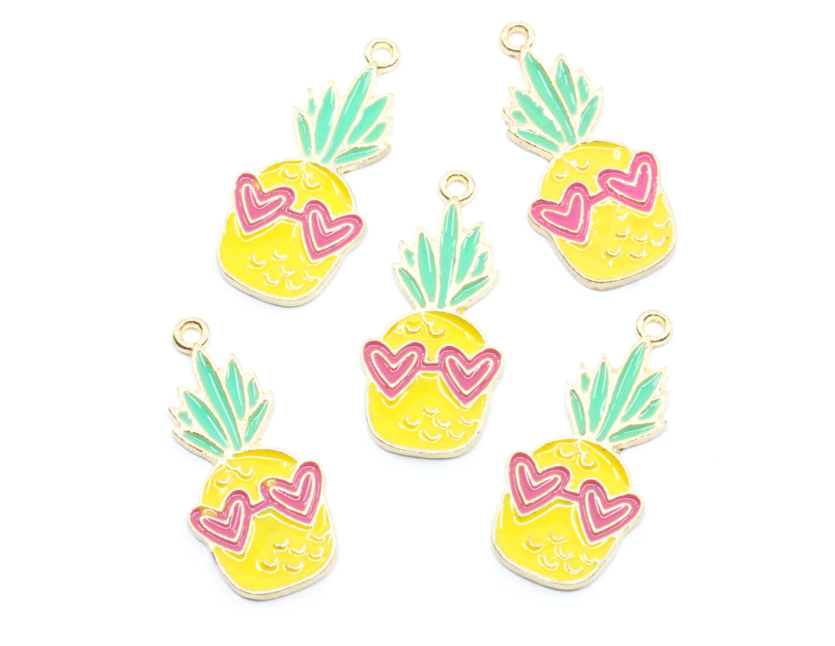 Five pineapple-shaped charms with yellow bodies, mint green leaves, and pink heart-shaped sunglasses, arranged on a plain white background.